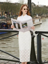 A lady wears a slit skirt.